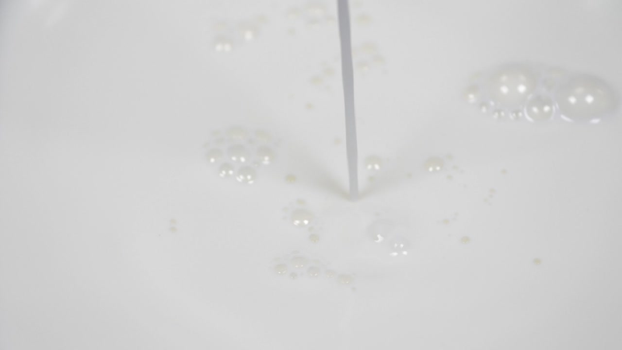 Pouring fresh milk in super slow motion 4k