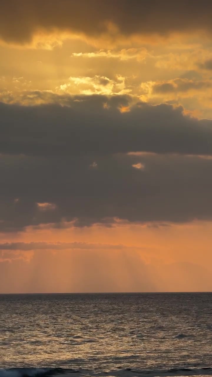 Golden Sunset Over the Ocean with Dramatic Clouds