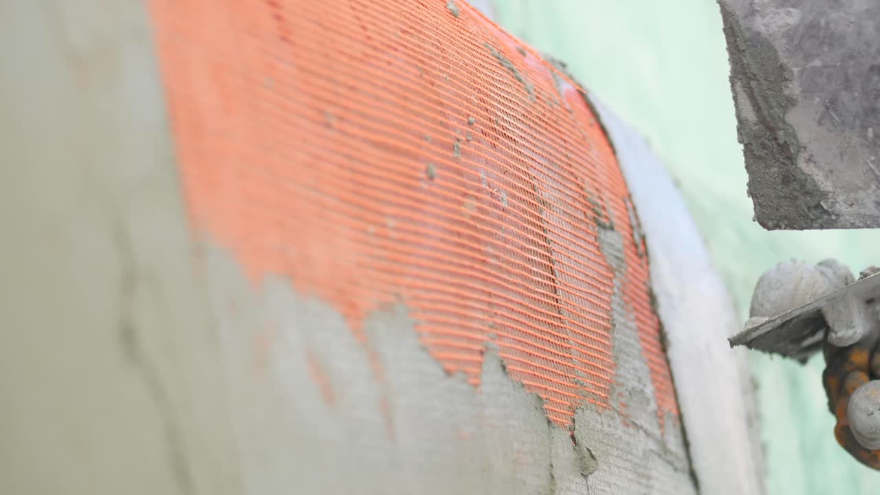 Renovation or Repair Work on a Building Exterior Wall with Plaster and Mesh