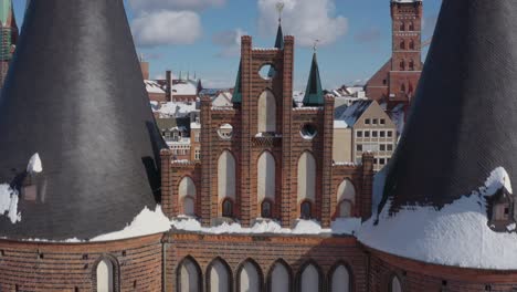 aerial view of the holsten gate in lübeck after snowing