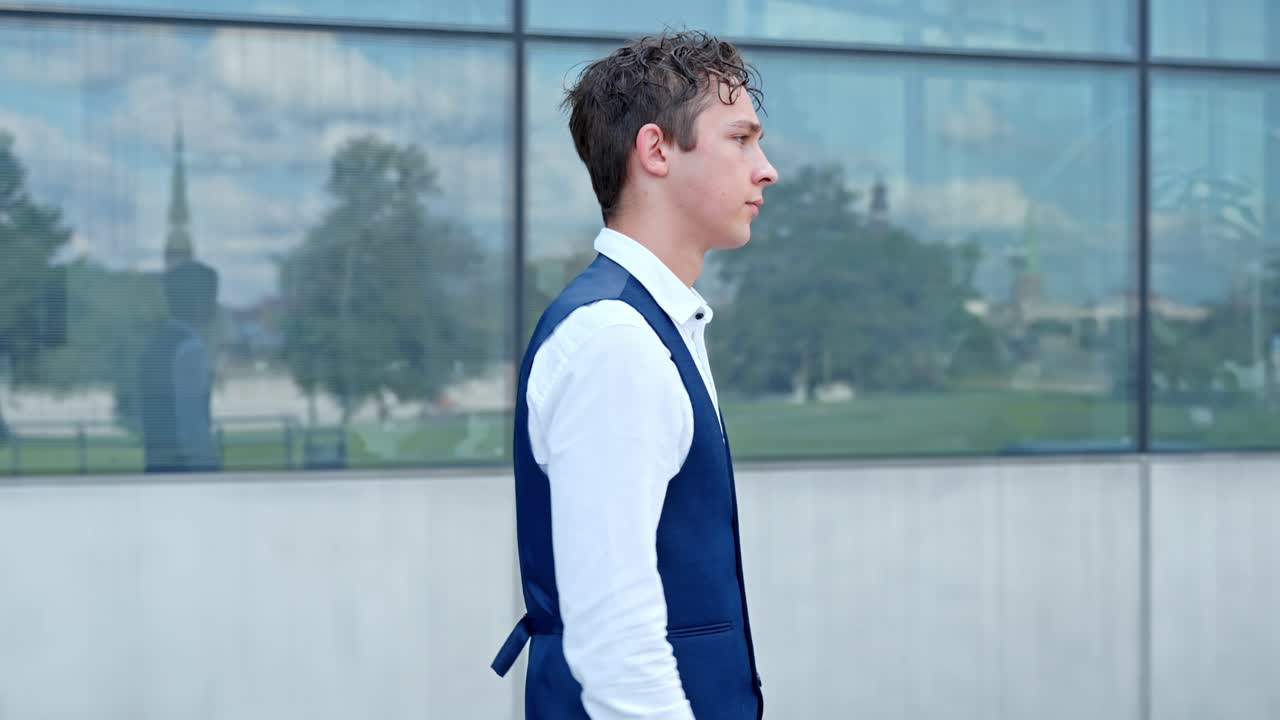 Young Financial Analyst Walking Outside Corporate Office - Medium Shot