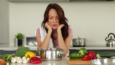 Puzzled-woman-looking-down-at-her-saucepan