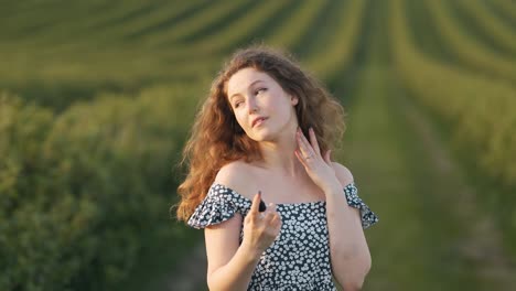 Portrait-of-a-young-woman-applying-spray-to-skin-for-protection