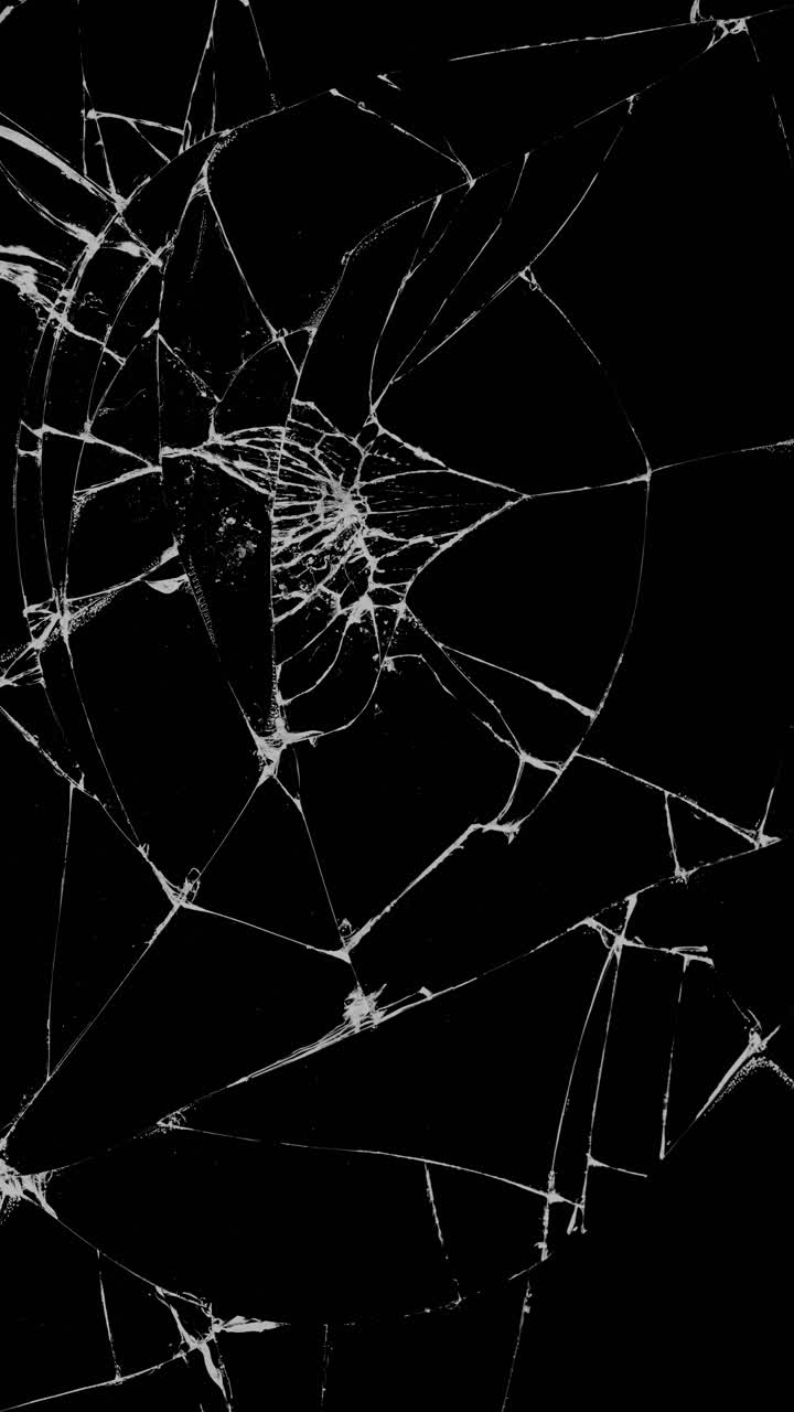 Realistic texture of shattered and cracked glass on an isolated black background for overlay or transition effects