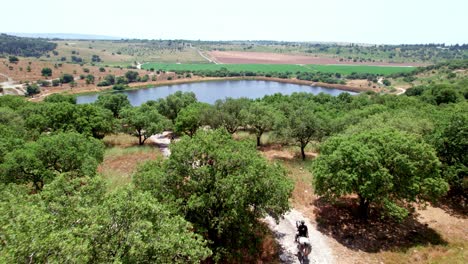 horseback riding next to a lake