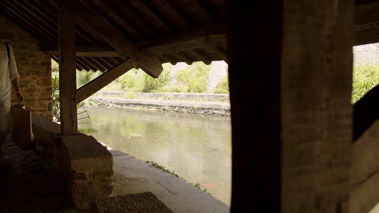 Flowing river through township of Vannes il Bretagne ,view from inside ancient building