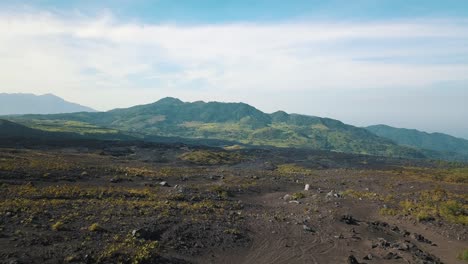 drone aerial shot of two girls standing on a rock, beautiful landscape with mountains in guatemala, central america