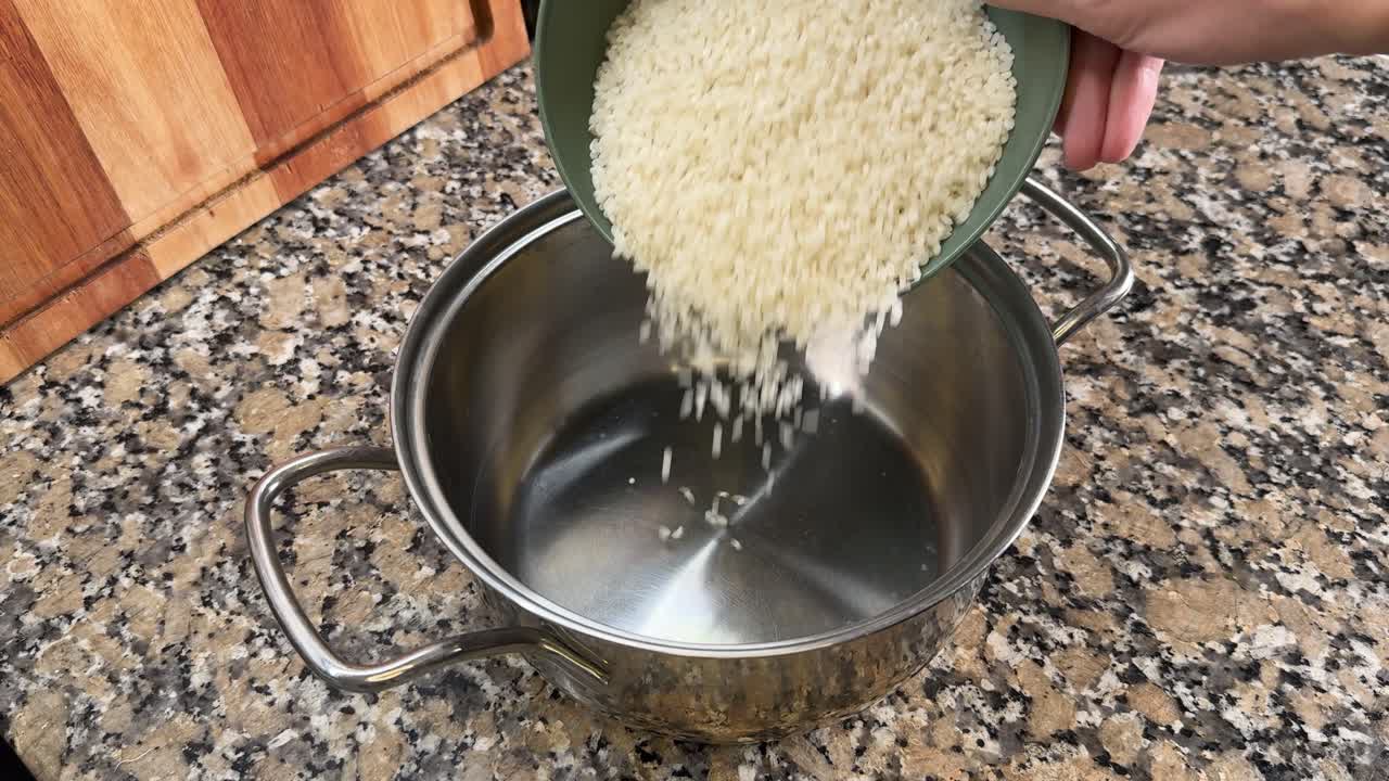 Rice is Poured Into a Pot to Begin Making Onigiri - Close Up