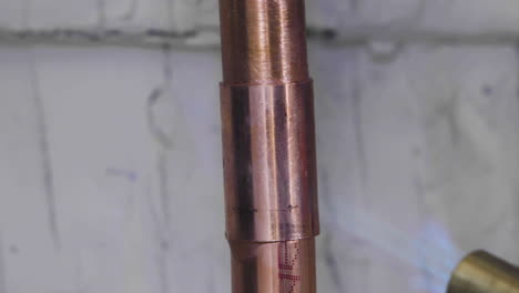 A-copper-pipe-is-welded-using-solder-and-a-propane-torch