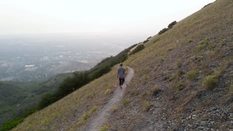 Mountainous-Nature-And-Girl-Hiking-With-Puppy-In-Wasatch-Mountains,-Utah,-USA---drone-shot