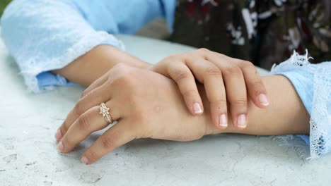 primer plano de la mano de una mujer con un anillo de diamantes