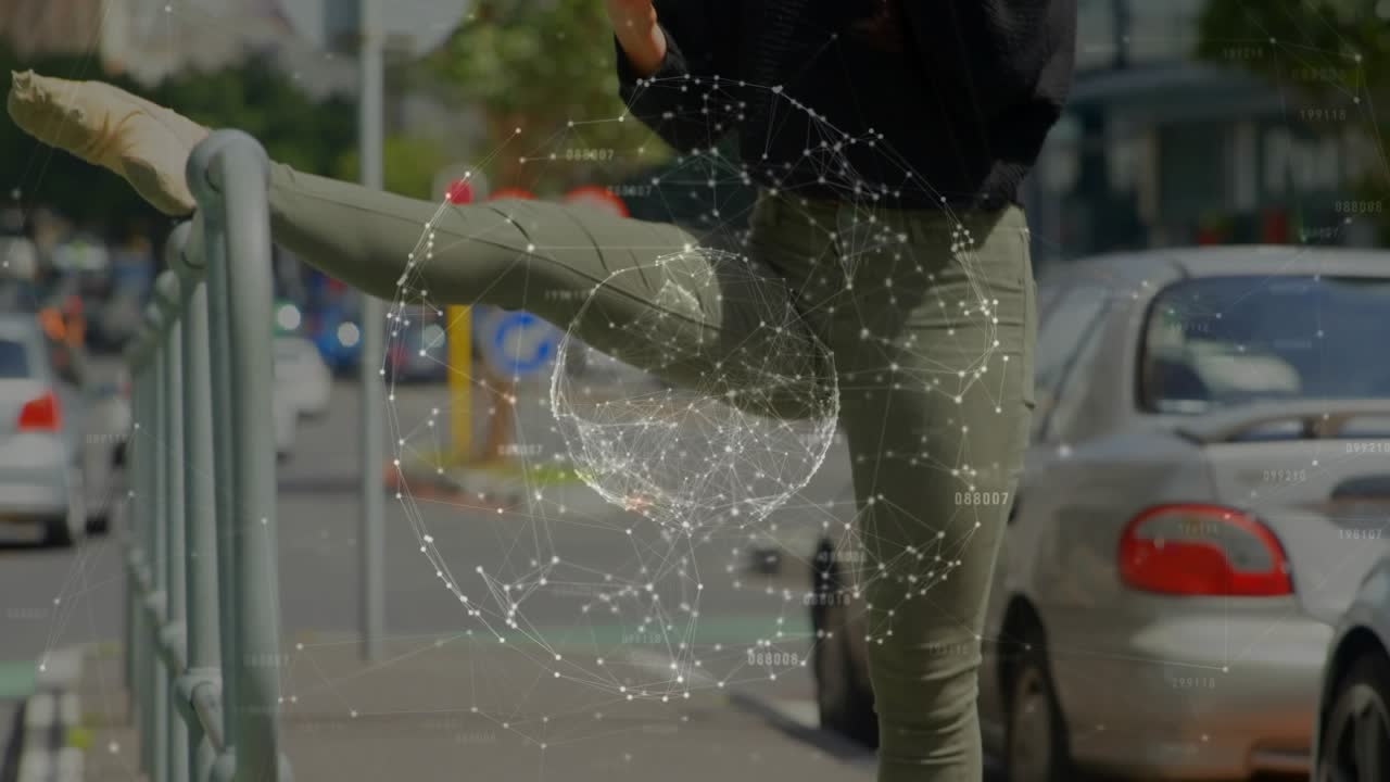 Woman stretching leg on railing while checking phone, posing for fashion tech sphere around torso