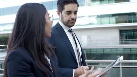 Business-colleagues-using-tablet-pc-on-street