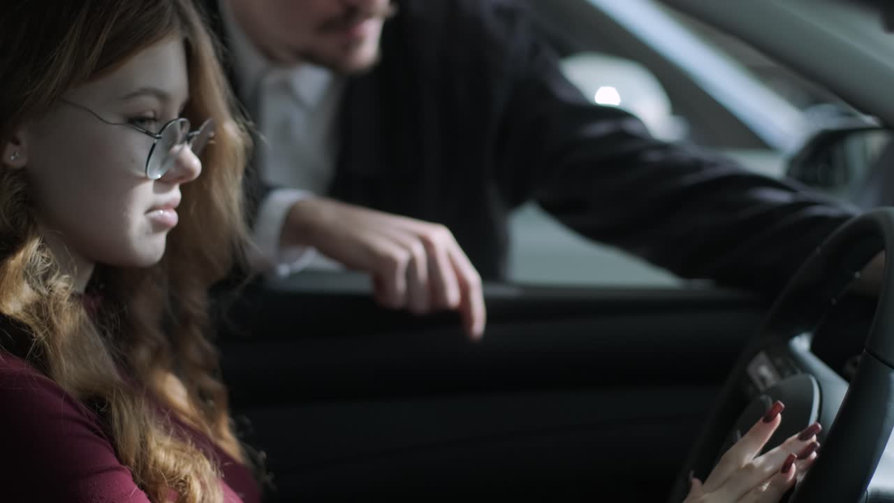 People in a car at a dealership