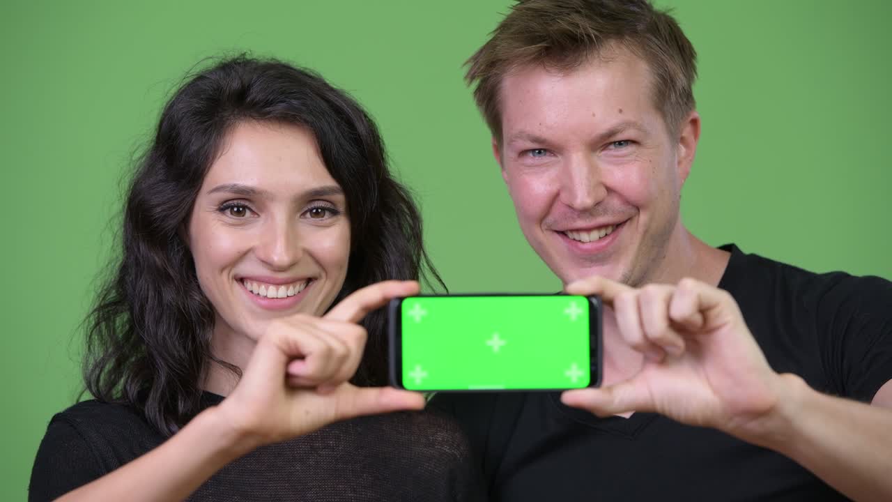 Young couple showing phone together