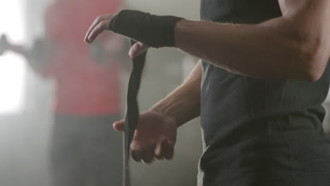 man wrapping hands with hand wraps