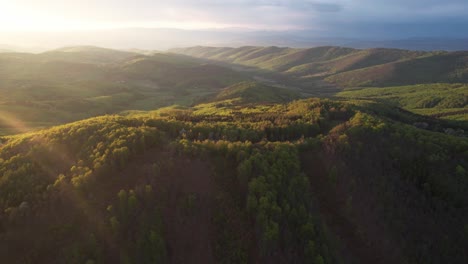 Stunning-Lower-Tatra-mountains-with-lush-forestry-at-sunset---aerial-high-above