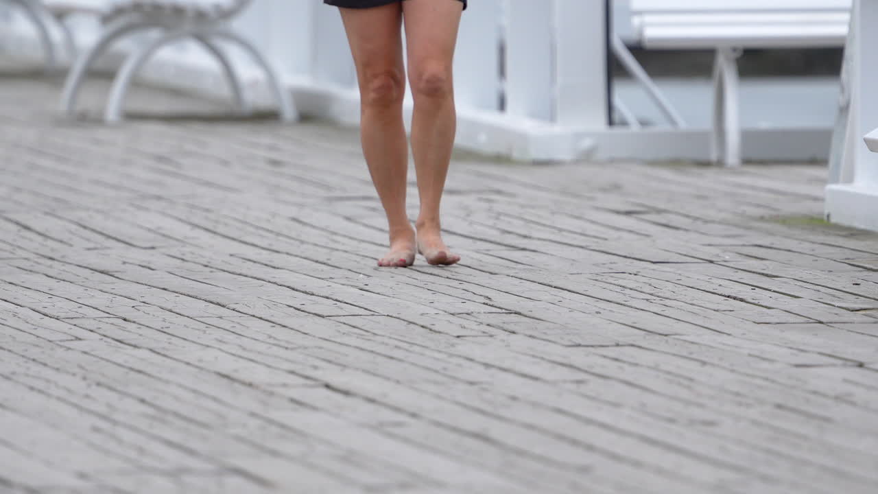 A Woman Embracing the Earth's Touch as She Walks Barefoot - Close Up