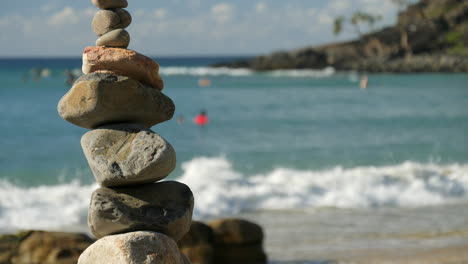 serene beach scene with stacked rocks