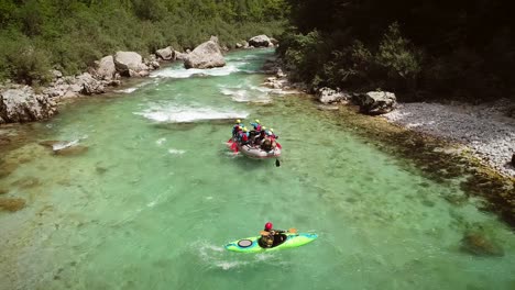 aerial view of a group in a rafting boat going through the rocks at soca river.