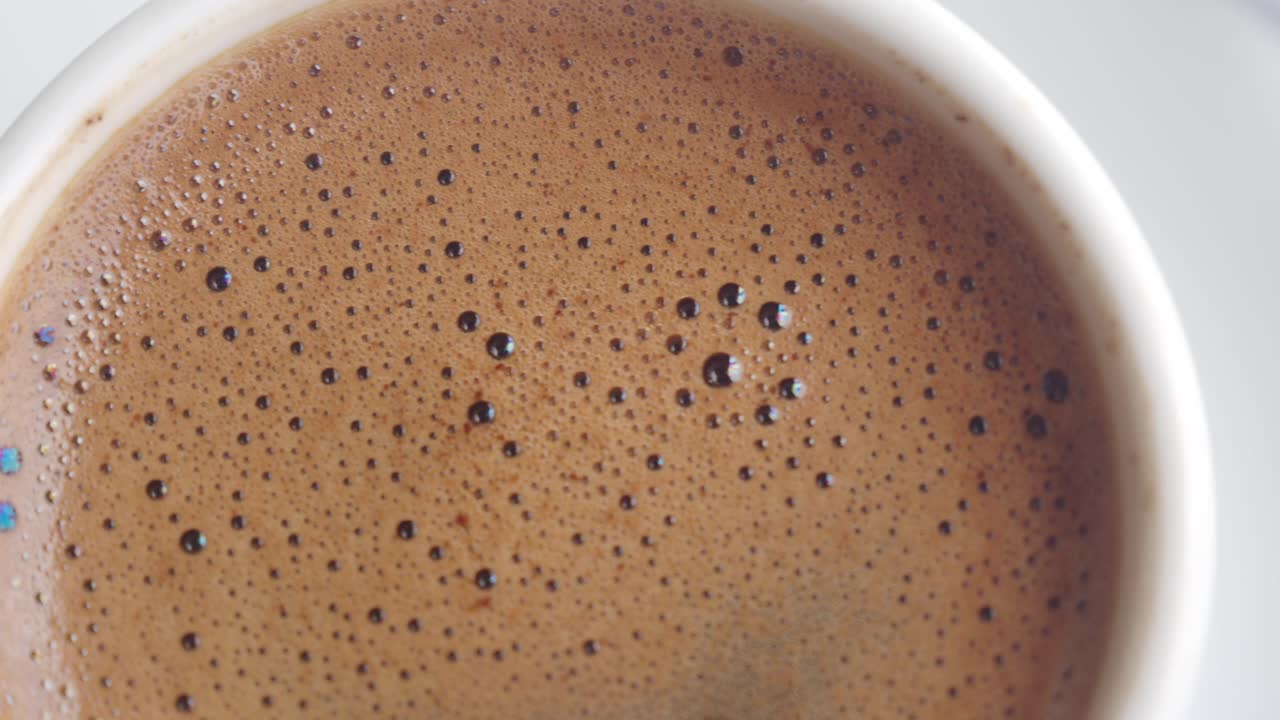 Close-up of foamy coffee in a white cup