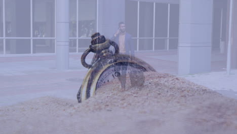 composite video of sand over a stopwatch against african american businessman with trolley bag