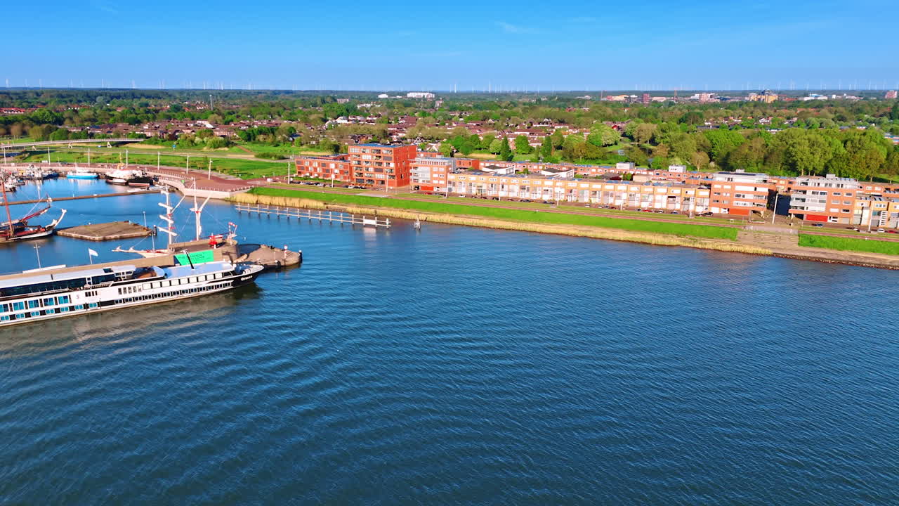 Ships on the waterscape of lake Markermeer in Lelystad, the Netherlands. Aerial view on the green city on sunny day.