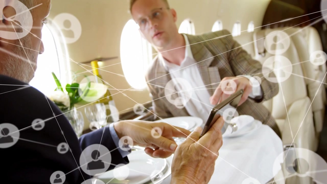 Animation of network of connections with people icons over caucasian business people on plane