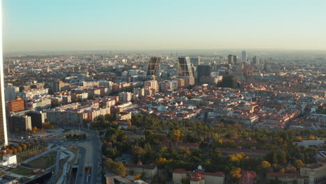 Descending-aerial-panoramic-footage-of-large-city.-Housing-estate-and-tall-modern-business-buildings.-Iconic-Gate-of-Europe-twin-towers.