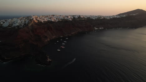 aerial view of santorini island greece at dusk, coastline and hilltop buildings