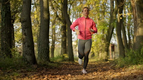 woman running on a path through an autumn park