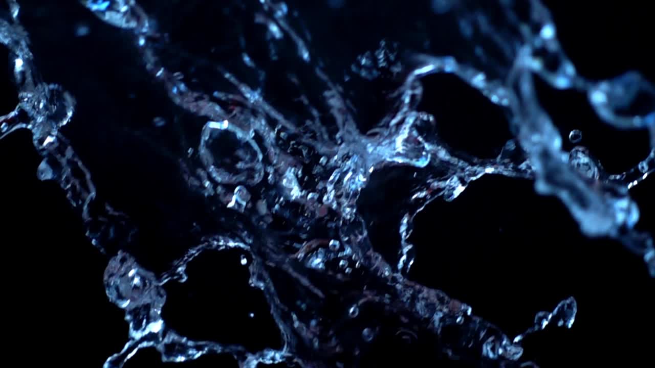 Acqua su sfondo nero. Slow motion.