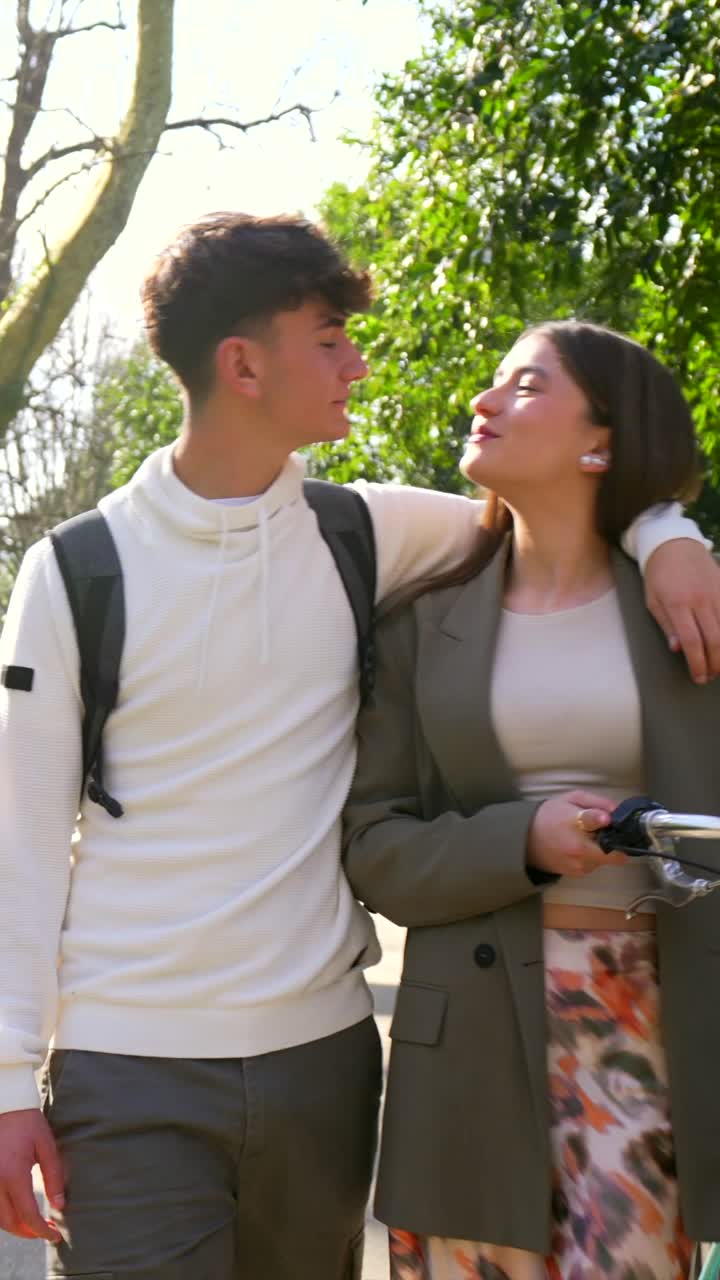 Couple with bicycle in a park