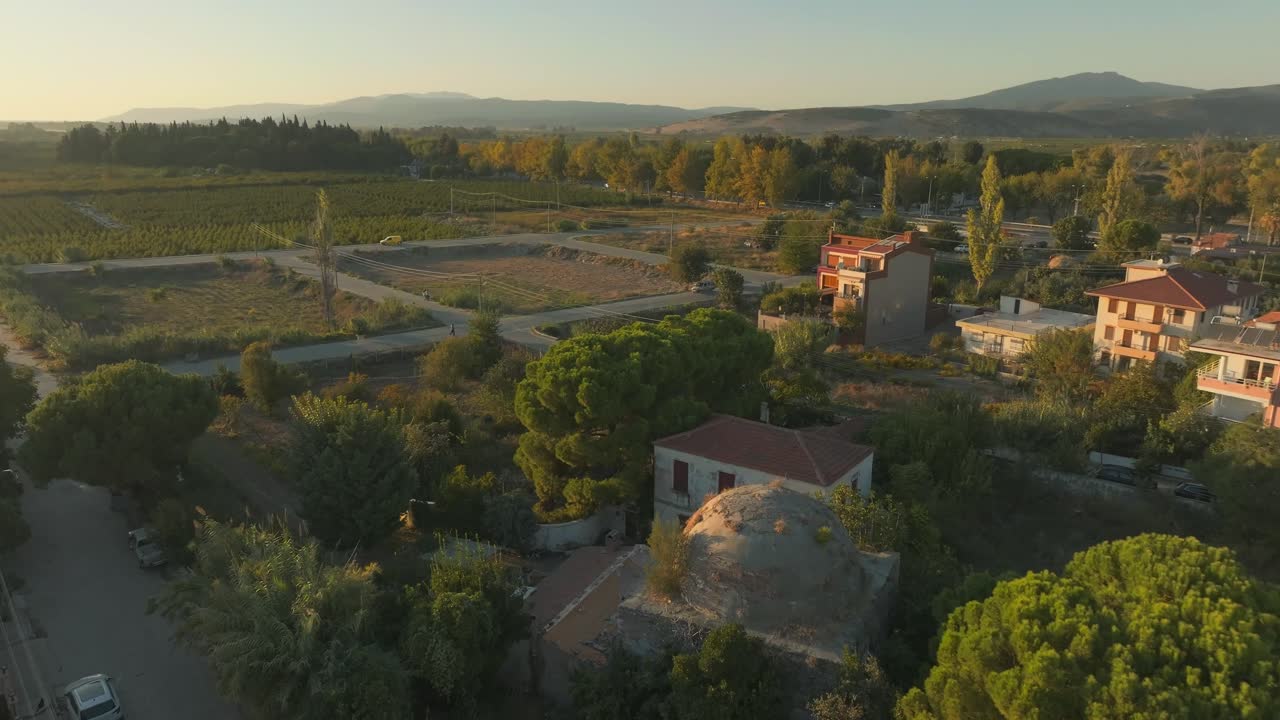 Aerial Drone over ancient overgrown bath house Hamam in Selcuk city, Turkey, plants growing over old buildings