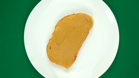 peanut butter sandwich rotates on a green background.