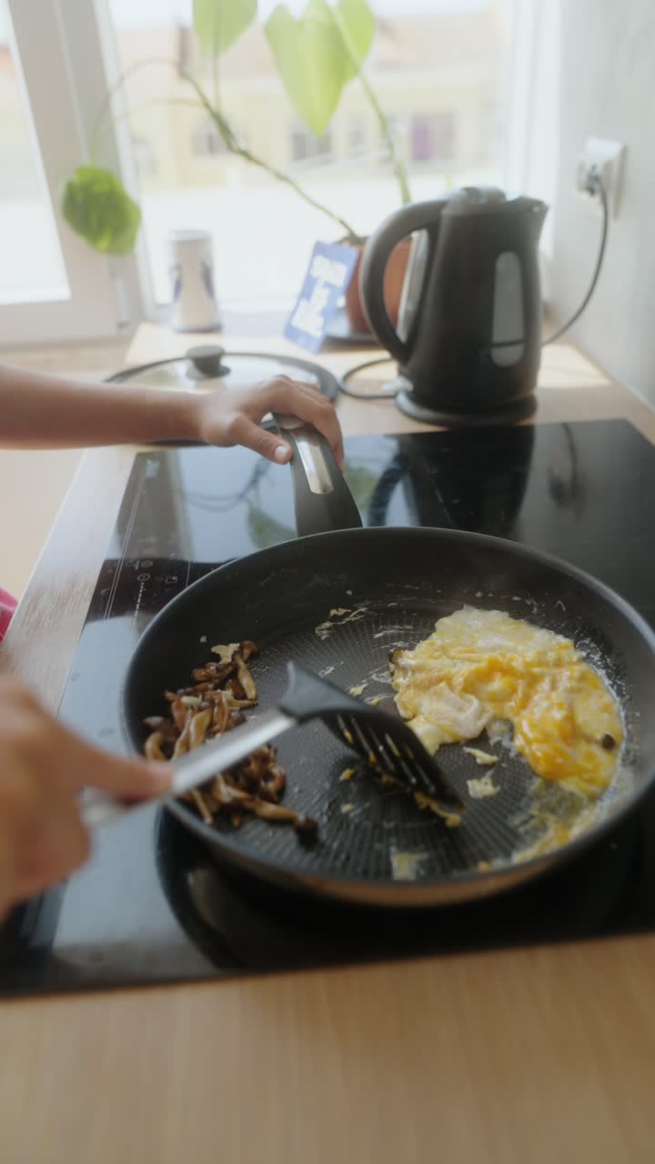 Cooking Breakfast with Eggs and Mushrooms