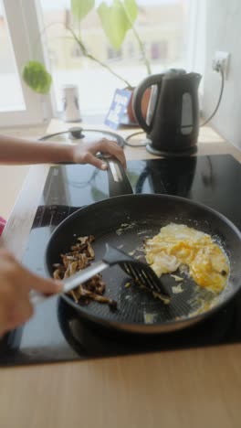 cooking breakfast with eggs and mushrooms