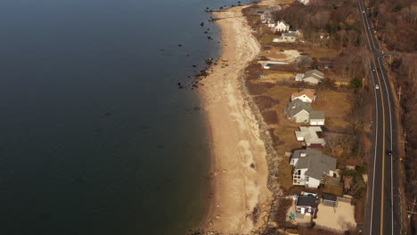 an-aerial-shot,-looking-down-along-an-empty-beach-while-it-was-quiet-and-peaceful-on-a-sunny-afternoon