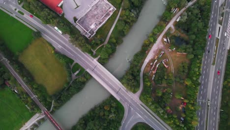 capture the mesmerizing beauty of a river and freeway weaving through nature stunning high-angle drone footage, showcasing the perfect harmony between man-made infrastructure and the natural world