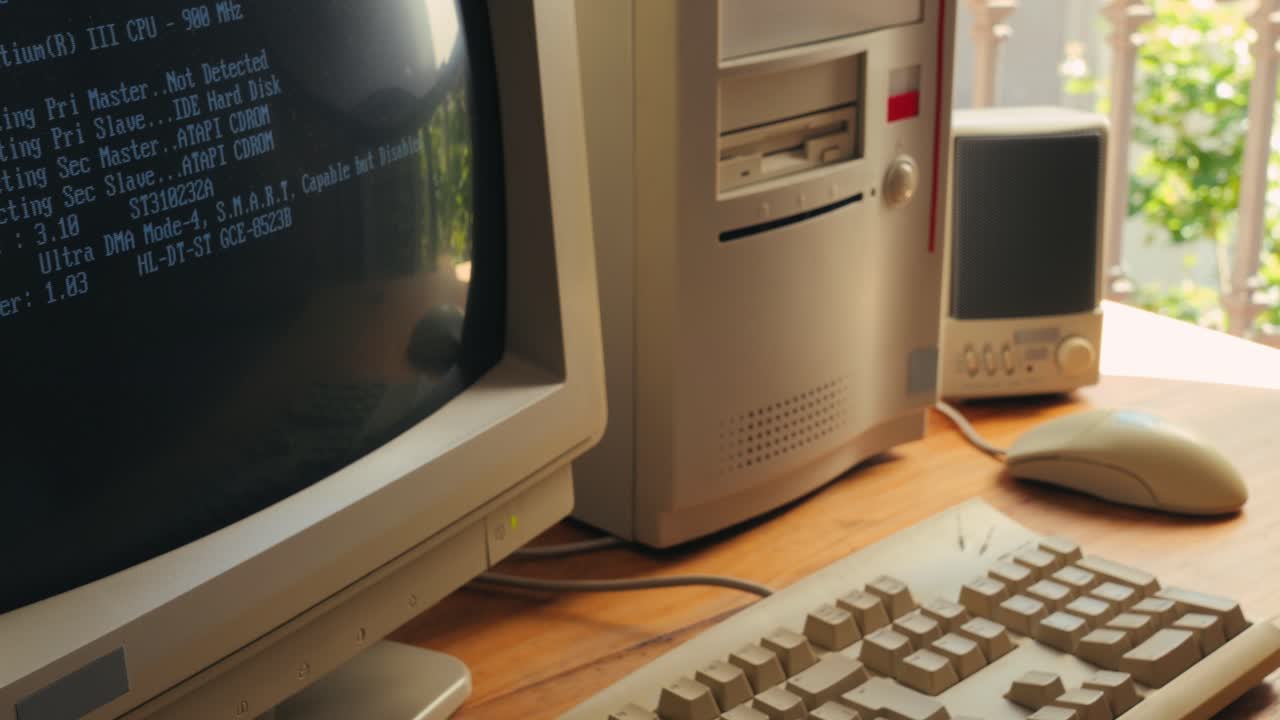 Man working and gaming on retro computer PC, IT engineer with vintage computer at home, using old fashion technology, close up of retro setup.
