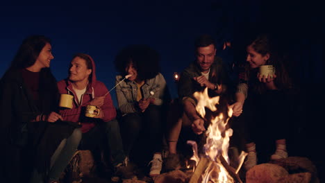 friends gathering around a campfire at