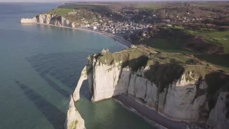 Aerial-drone-shot-of-Etretat-along-the-seaside-cliffs-in-Normandy-at-Northern-France