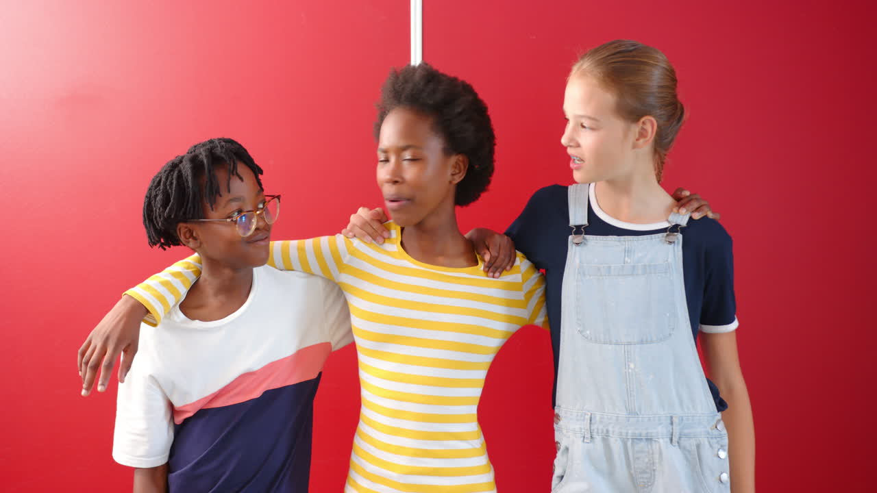 Smiling children standing together, arms around each other, in school setting