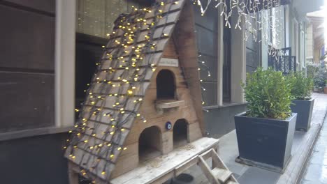 cute wooden cat house decorated with christmas lights