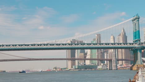 american iconic brooklyn bridge over east river with new york city teal skyline