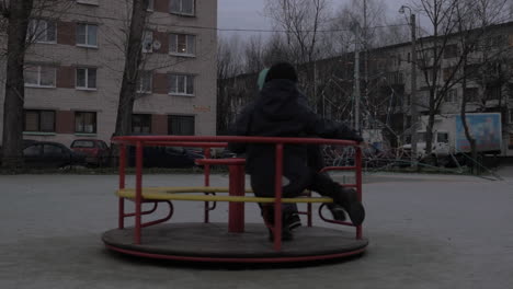 children having fun on merry-go-round in the yard