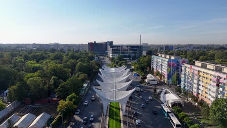drone view over the heroes' gate monument in eroii revolutiei square with morning traffic below, bucharest, romania