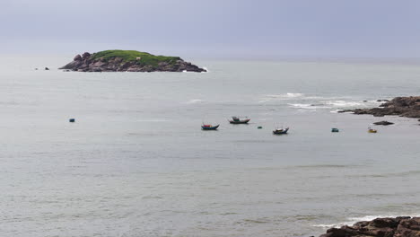 aerial view of rocky island and fishing boats at hai long bay in mui ne, vietnam