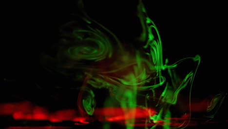 green and red shapes moving on black background, abstract background