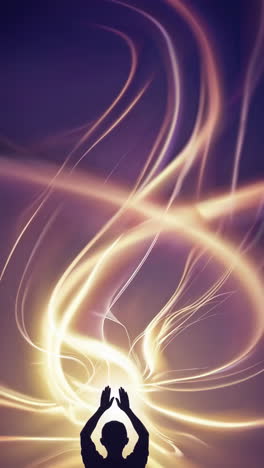 silhouette of a person with hands raised in abstract light trails